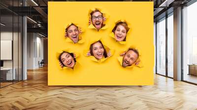 Excited people tearing yellow paper Wall mural