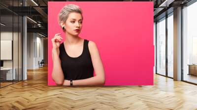 Girl with short blond dyed hair over pink background Wall mural