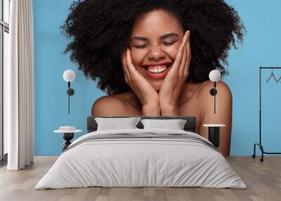 Happy African American woman with perfect skin on blue background Wall mural