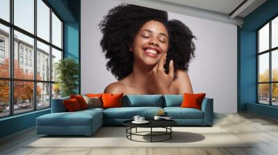 Happy black lady touching soft skin Wall mural