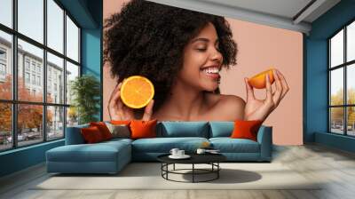 Happy ethnic woman with citrus Wall mural