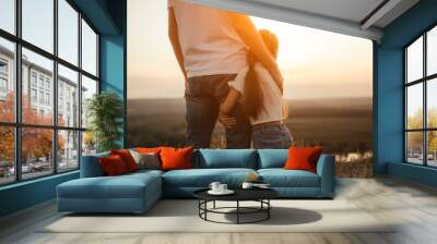 Happy father and daughter hugging while standing at countryside Wall mural