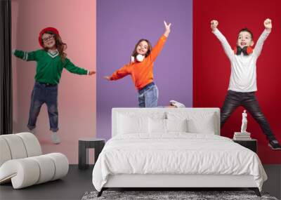 Joyful diverse little girls and boys having fun in studio Wall mural