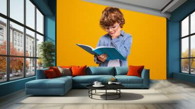 Little boy reading interesting book Wall mural