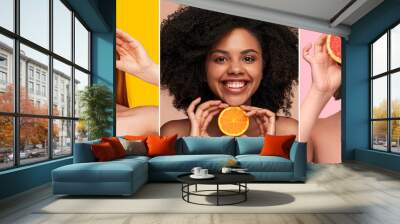 Optimistic multiracial women showing fresh citruses Wall mural