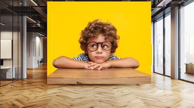 Pensive charming boy on studio background Wall mural