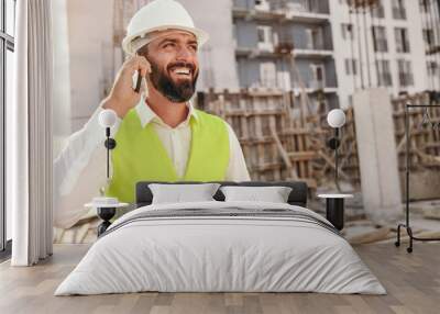 Positive construction inspector talking on phone Wall mural