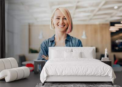 Positive young casual woman looking at camera Wall mural