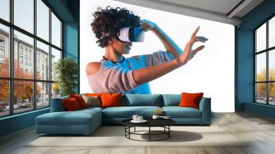 Pretty woman wearing VR goggles touching air Wall mural