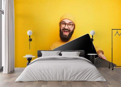 smiling hipster in glasses posing with laptop Wall mural