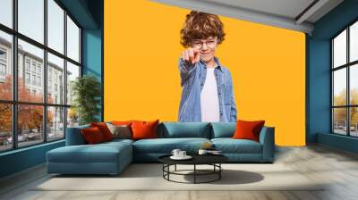 Stylish kid pointing with forefinger at camera Wall mural