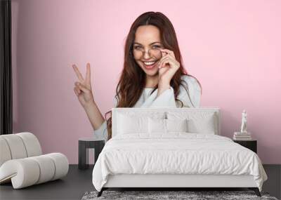 Trendy hipster girl showing two fingers Wall mural