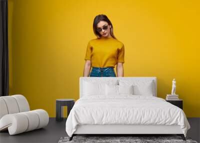 Trendy woman in bright clothes and sunglasses Wall mural