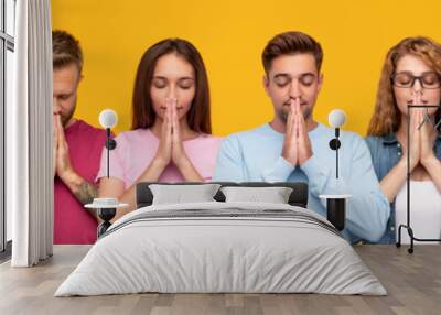 Young people praying with clasped hands Wall mural