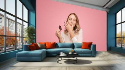 Young woman with chocolate licking finger Wall mural