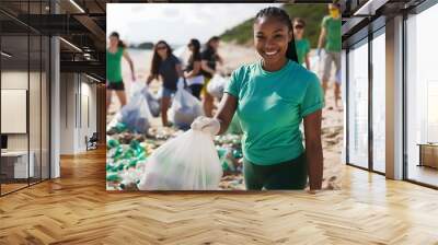 Diverse multicultural students volunteer cleaning up beach from plastic waste at sea shore, environmental protection, trash collection Wall mural