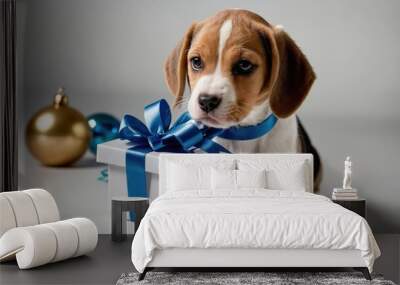 A playful beagle puppy beside a gift box, evoking a festive and joyful atmosphere. Wall mural