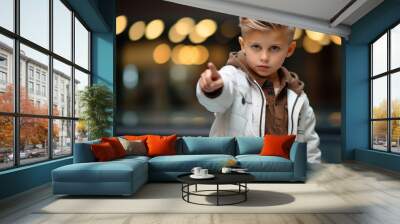 10 year old boy with short blond hair pointing at the camera towards you Wall mural