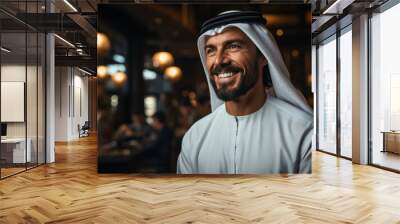 Arabic man indoor smiling while wearing traditional white Shemagh gown with black agal Wall mural