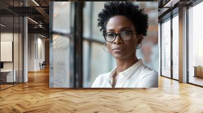 Beautiful 45 years old gentle black African American woman, wearing glasses, formal slick hairstyle, smooth face in a modern office building, wearing white shirt, beside a huge window Wall mural