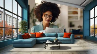 Black afro American woman enjoying a quiet morning routine at home, dressed in casual attire, she sips on a cup of coffee, reads the newspaper before heading to the office Wall mural