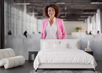 Business woman wearing pink blazer with office background Wall mural