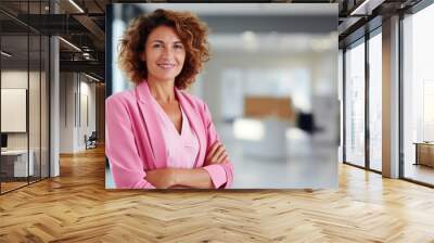 Business woman wearing pink blazer with office background Wall mural