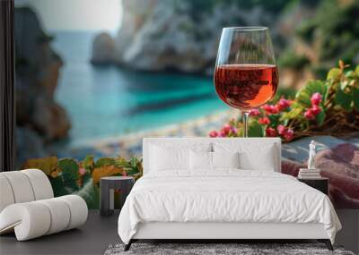 Close-up of rosé wine glass on a beach towel, with a blurred background of a beach scene, copy space Wall mural