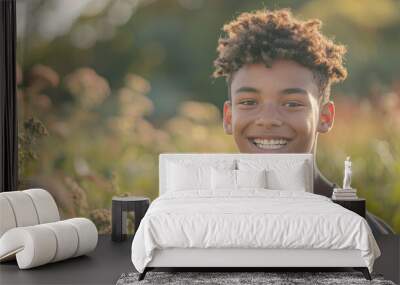 Happy 15 years old teenage boy portrait in middle of beautiful nature of a field with copy space Wall mural