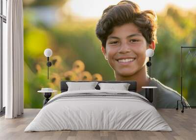 Happy 15 years old teenage boy portrait in middle of beautiful nature of a field with copy space Wall mural