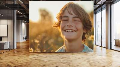 Happy 15 years old teenage boy portrait in middle of beautiful nature of a field with copy space Wall mural