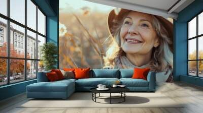 Happy mature woman portrait in middle of beautiful nature field with copy space Wall mural