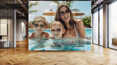 Happy mother and two children family at swimming pool during summer holidays travel Wall mural