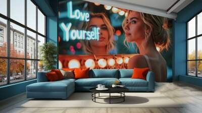 Love yourself concept image with beautiful blonde woman looking herself in the mirror and glowing sign love yourself message Wall mural