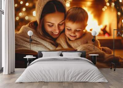 Mother and her child cuddled up under a blanket, reading a storybook by the warm glow of a fireplace , family Winter Storytime concept image Wall mural