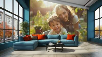 Mother gardening with her young son in their garden , family enjoying sun outside in their backyard Wall mural