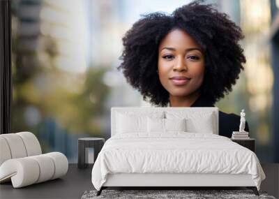 Portrait of a beautiful black afro american woman in suit outdoors with a blurry business center in backdrop Wall mural