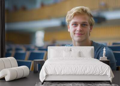 Portrait of a blond hair nordic caucasian happy university student sitting in a college lecture hall Wall mural