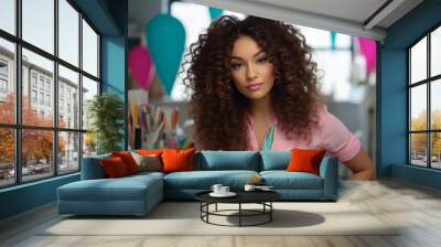 Portrait of a creative designer mixed raced woman with long curly hair as a graphic designer in a white chic office with colorful sticky notes in the background Wall mural