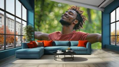 Portrait of a free happy black afro american man with open arms enjoying life in meadows and nature background , young joyful African male with good mental health Wall mural