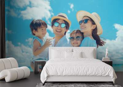 Portrait of a Japanese Asian family on holidays at the beach with beautiful blue sky and copy space Wall mural