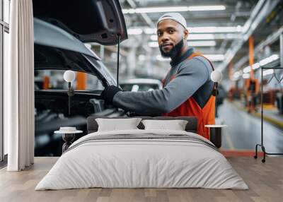 Portrait of a man worker working on a car assembly line for automotive industry Wall mural