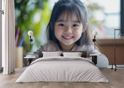 Portrait of a young Asian Japanese girl kid sitting at the dining table doing homework, math problems with a smile Wall mural