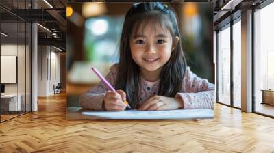 Portrait of a young Asian Japanese girl kid sitting at the dining table doing homework, math problems with a smile Wall mural