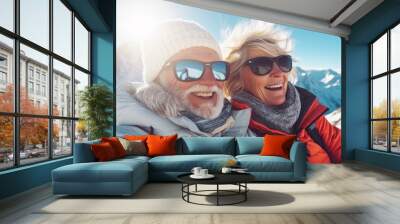 Portrait of old elderly couple at top of snowy mountain for winter sports holidays Wall mural