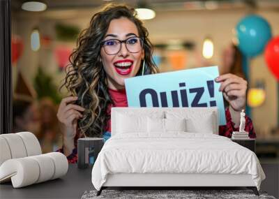 Quiz concept image with happy woman holding a board sign with written word Quiz inside an open space office at work Wall mural