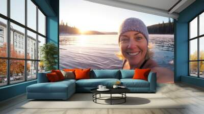 Selfie image of happy adult woman swim in the lake in middle of beautiful natural winter snowy landscape Wall mural