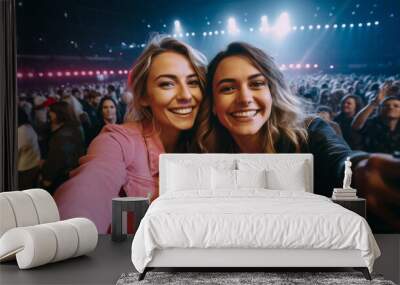 Selfie image of two young women at a concert in a giant indoor arena Wall mural