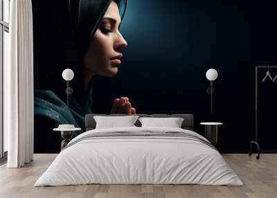 Side view of a woman praying at night, night mood with copy space Wall mural