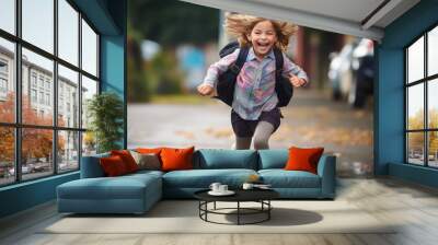 Small schoolgirl with satchel running to school smiling , back to school concept Wall mural